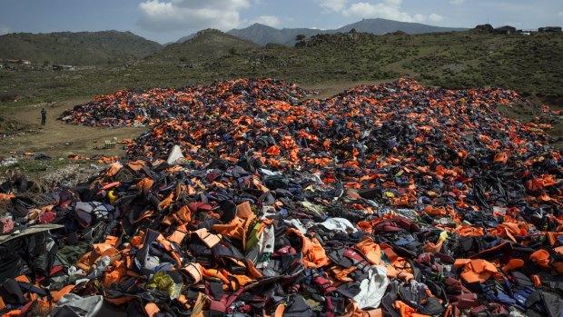 A pile of thousands of discarded life vests  dumped in a valley in hills above the town of Mithymna on Lesbos, Greece, on Monday. 