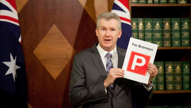 Labor finance spokesman Tony Burke waving a print of a "P" plate for Speaker Bronwyn Bishop.
