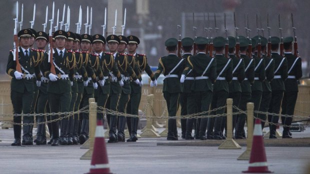 Chinese paramilitary police march during a flag raising ceremony in Tiananmen Square outside the Great Hall of the People on Saturday. 