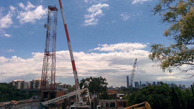 The antenna tower at the old ABC studios in Toowong is demolished on Monday, February 2.