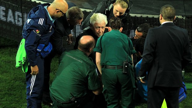 He's ok: Frank Lowy receives assistance after his mishap on the podium.