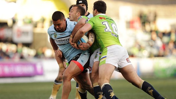Powerhouse: Andrew Fifita tries to get through the Raiders defence last week.