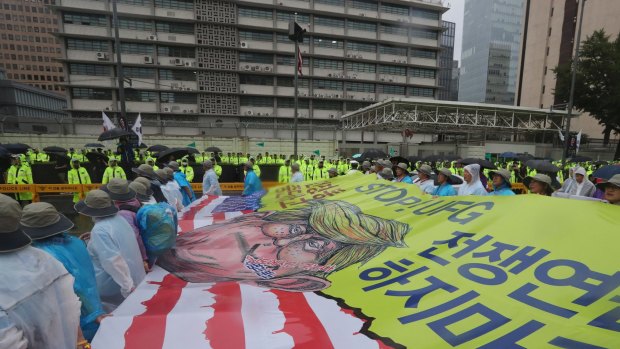Protesters march in front of the US Embassy after a rally in Seoul demanding peace on the Korean peninsula.