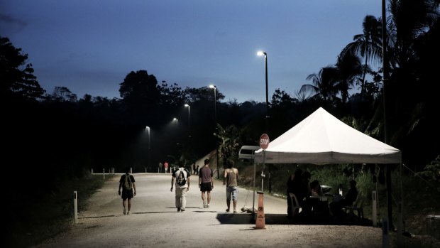 Refugees pass the security checkpoint as they return to the East Lorengau Transit Centre on Manus Island.