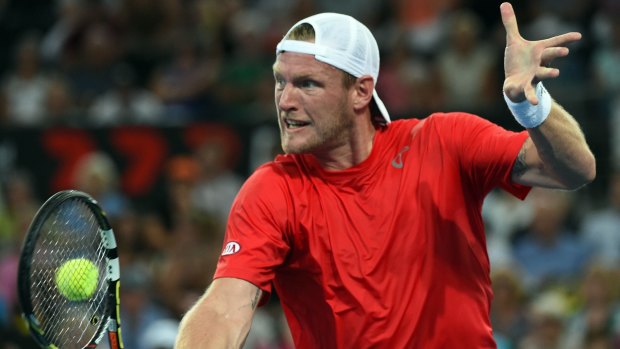 Sam Groth of Australia hits a return against Lukasz Kubot of Poland during their men's singles second round match at the Brisbane International.
