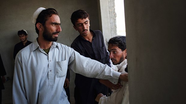 Men gather in one of the incomplete houses in  Amanullah Khan town in Afghanistan. The emergence of Islamic State in the region has ushered in a new age of brutality. 