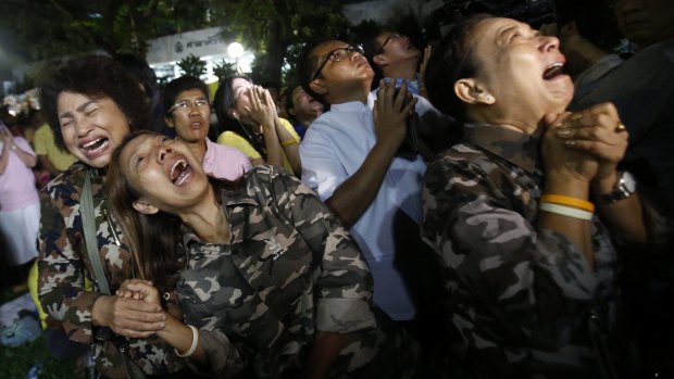 People cry outside Siriraj Hospital after the death was announced.