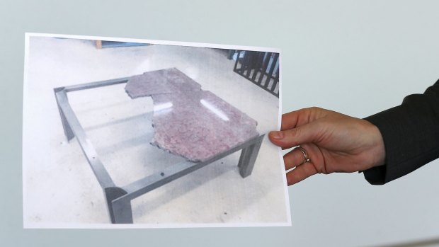 A photograph of the damaged table.