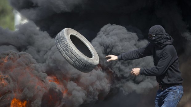 Palestinians burn tyres during clashes with Israeli troops near Ramallah, West Bank, on Friday.
