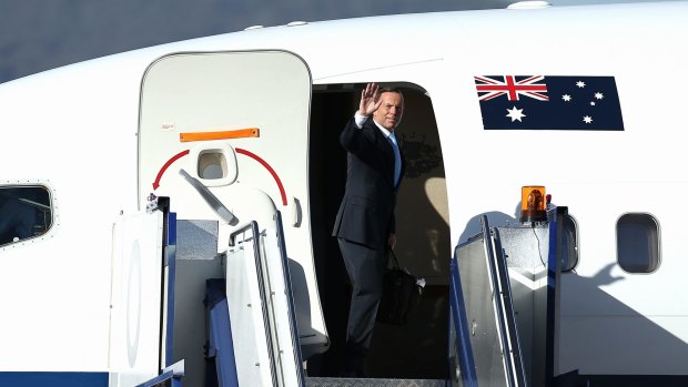 Focusing on jobs: Tony Abbott boards his flight for APEC in Beijing.