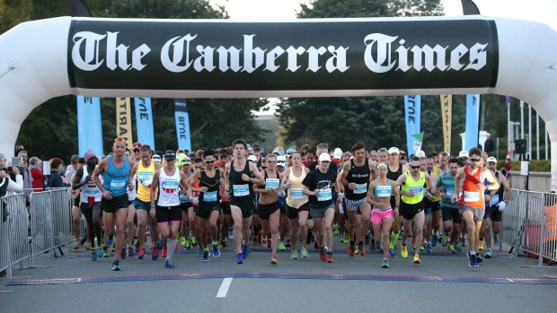 Runners set of the start line at the beginning of the Canberra Times Marathon in front of Old Parliament House.  