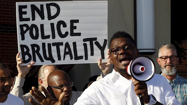 Pastor Derrick Golden speaks during a protest against what demonstrators call police brutality after a pool party in McKinney, Texas.