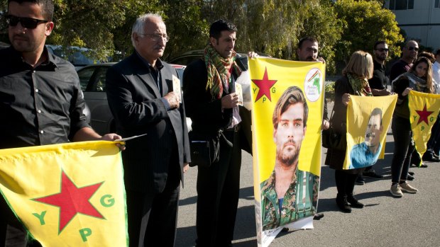 Members of the Kurdish community gather to pay tribute to Reece Harding at his funeral on Saturday.