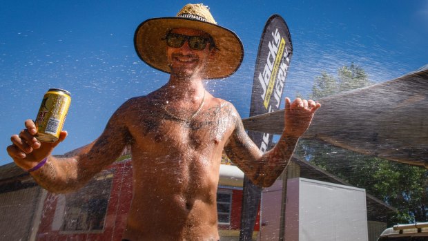 Chris Barac from Bonython is hosed down during the heat of the day at Summernats. 
