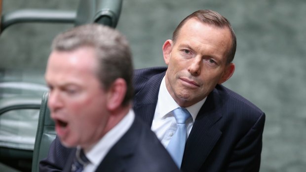 Prime Minister Tony Abbott listens as Leader of the House Christopher Pyne speaks during Question Time.