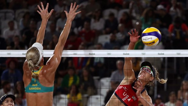 April Ross of United States spikes the ball against Louise Bawden of Australia in their quarter-final.