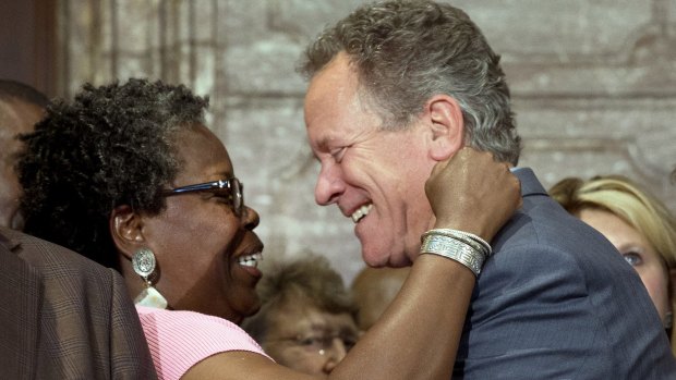 Representative Gilda Cobb-Hunter, left, reacts with former South Carolina Governor David Beasley after a ceremony where Governor Nikki Haley signed a bill to remove the Confederate flag.