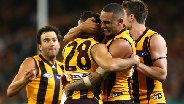 Hawks on high: Shaun Burgoyne embraces Paul Puopolo after the siren in the win against Adelaide.