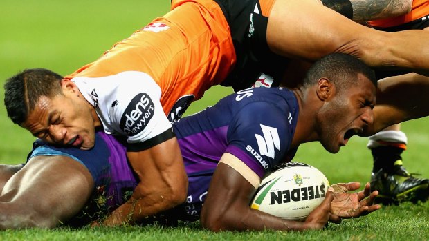 Melbourne Storm's Suliasi Vunivalu gets crunched earlier this year.