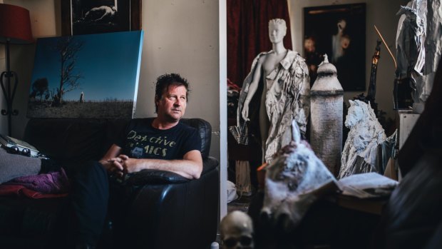 Canberra artist Stephen Harrison at home with some of his work.