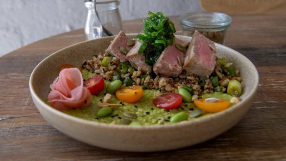 Seared tuna bowl with quinoa, brown rice, avocado, edamame, pickled ginger and seaweed.