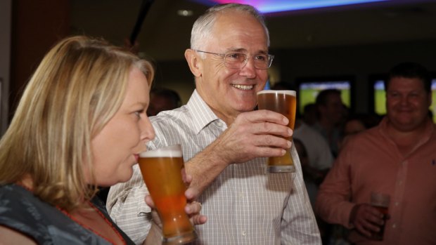 Prime Minister Malcolm Turnbull drinks beer with former Liberal MP Natasha Griggs in Darwin.