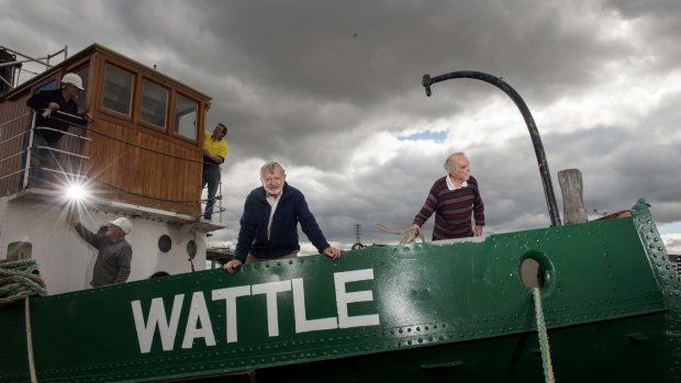 Tony Lewis, centre front, and fellow volunteers restoring the steam tug Wattle.