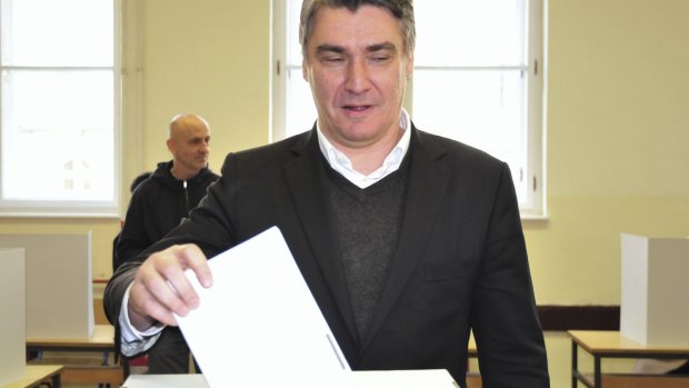 Croatian Prime Minister Zoran Milanovic votes at a polling station in Zagreb on Sunday.
