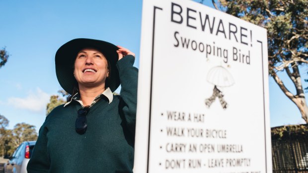 Ranger Nadia Rhodes suggests a hat or umbrella as the best ways to protect against swooping magpies.