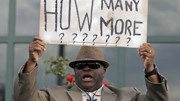 Reverend Dr Arthur Prioleau holds a sign during a protest in the shooting death of Walter Scott at city hall in South Carolina in April. 