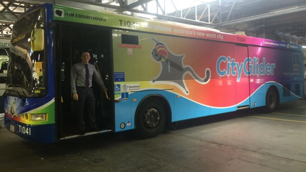 Brisbane City Council's public transport chairman Peter Matic with the Brisbane Pride Festival-themed rainbow bus. A resident has complained about advertising restricting the view from inside the bus.