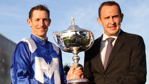 Cup success: Jockey Hugh Bowman and trainer Chris Waller celebrate after winning the Queensland Oaks with Winx. 