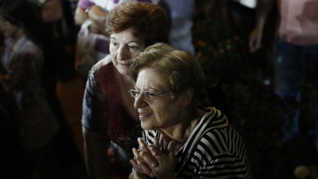 Supporters of the Syriza party look on as Alexis Tsipras speaks on Friday.