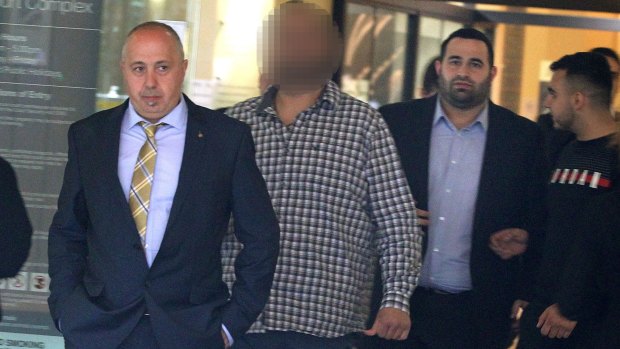 Denial Sfeir (left) and Abdul Rustom (right, in blue shirt) at the Downing Centre District Court on Monday. 