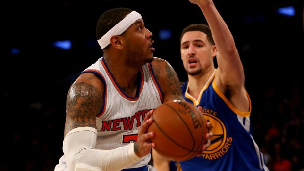 Tight defence: Carmelo Anthony heads for the net as Klay Thompson moves in.