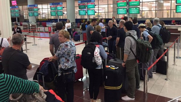 Passengers queue in hope of return to Sydney at Dubai International Airport