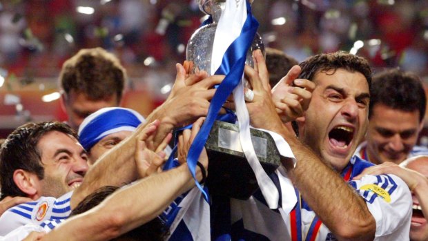 Rare upset: Traianos Dellas and teammates celebrate Greece's 1-0 win over Portugal in the Euro 2004 final in Lisbon.
