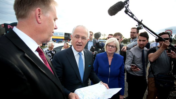 Prime Minister Malcolm Turnbull speaks with Liberal Member for Forde Bert Van Manen and Liberal Member for McPherson Karen Andrews as a political bunfight began over Pacific Highway funding in July 2016.