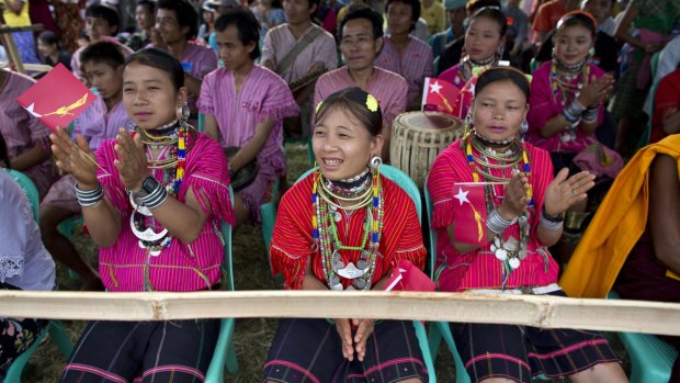 Ethnic Kayaw women in traditional attire applaud as Myanmar's opposition leader Aung San Suu Kyi delivers a speech during a campaign rally of her National League for Democracy party in Loikaw, Eastern Kayah State. 