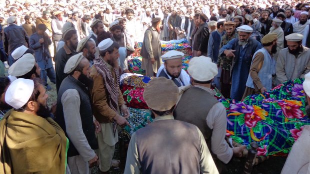 Villagers attend a funeral for people killed by Monday's earthquake in Chawkay district of Kunar Province east of Kabul, Afghanistan.