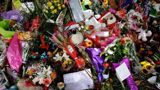 Mourners leave flowers and toys, paying tribute to the eight children who died in the Cairns house.