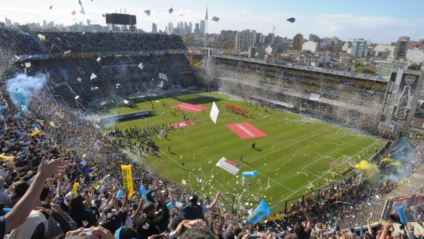 Boca Juniors fans cheer prior to an Argentine soccer league game against River Plate at La Bombonera stadium in Buenos Aires.