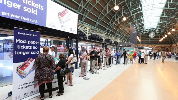 Commuters queue to buy Opal cards as paper tickets are phased out. 