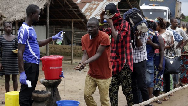 An Ebola temperature check and washing station on the edge of a quarantined area in Sierra Leone.