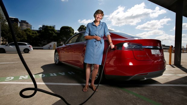 Tesla electric car owner Sally Perini, at a charging station on top of Westfield Chatswood.
