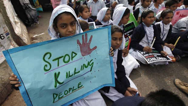 Lost lives: Students hold a vigil for the victims of the Taliban attack on the Army Public School in Peshawar. 