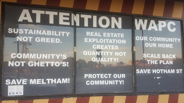 Protest signs at a Meltham shopfront. 