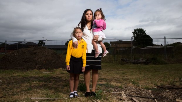 Diane Trang Wilson with her children Bronwyn, six, and Adelyn, one, in front of the plot they bought as a house and land package in 2013.