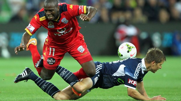 Adrian Leijer tangles with Bruce Djite in the frenzied clash between Victory and Adelaide.