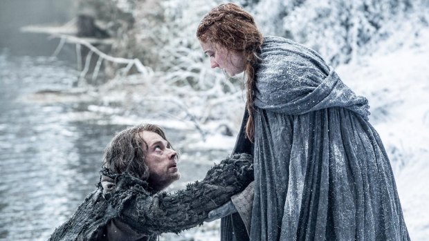 Alfie Allen as Theon Greyjoy and Sophie Turner as Sansa Stark.